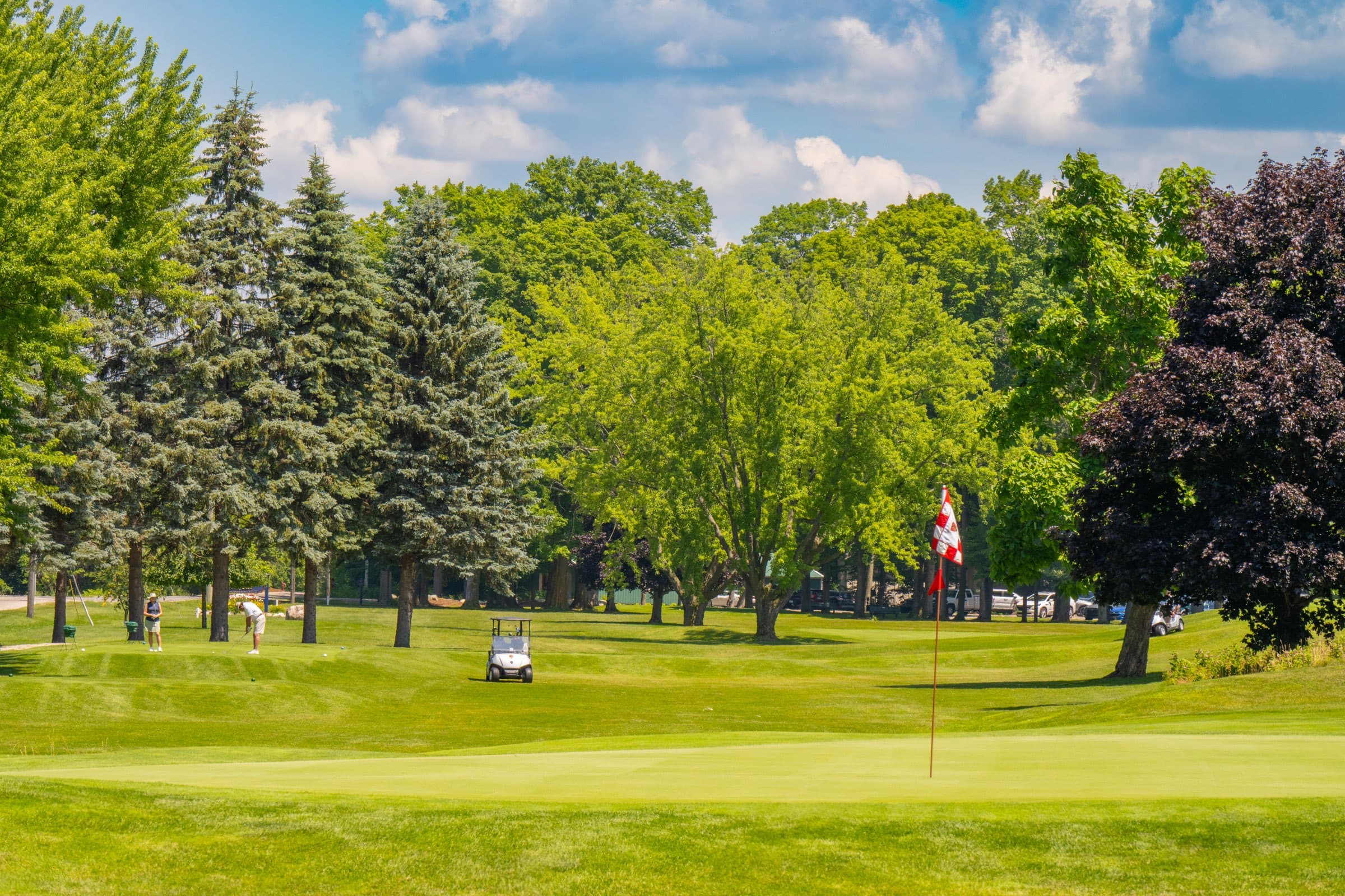 Golfers on a green at the Elk Rapids Public Golf Course, across the street from Vacation Village