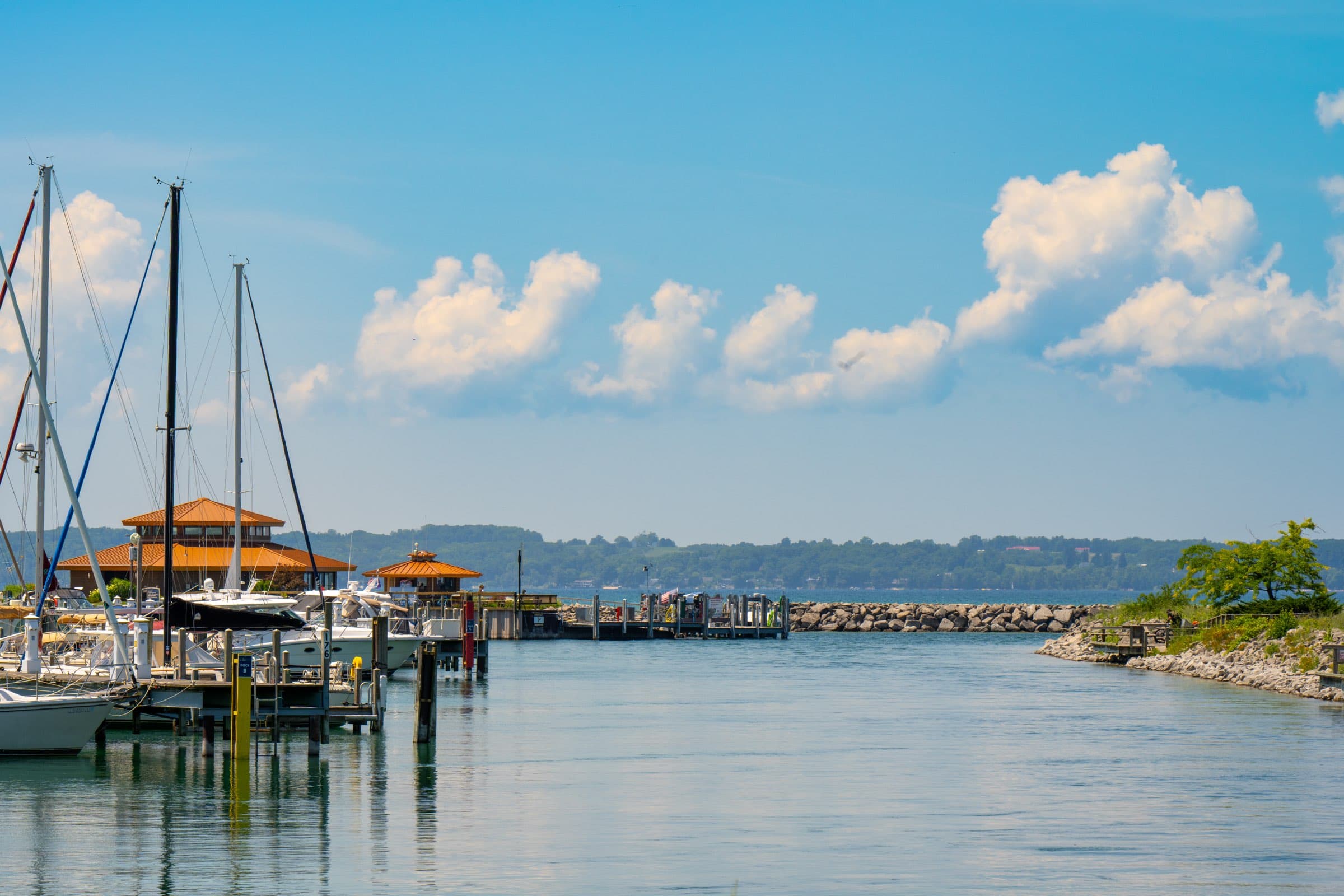 Sailboats moored at the Elk Rapids harbor, with the breakwater and Grand Traverse Bay beyond
