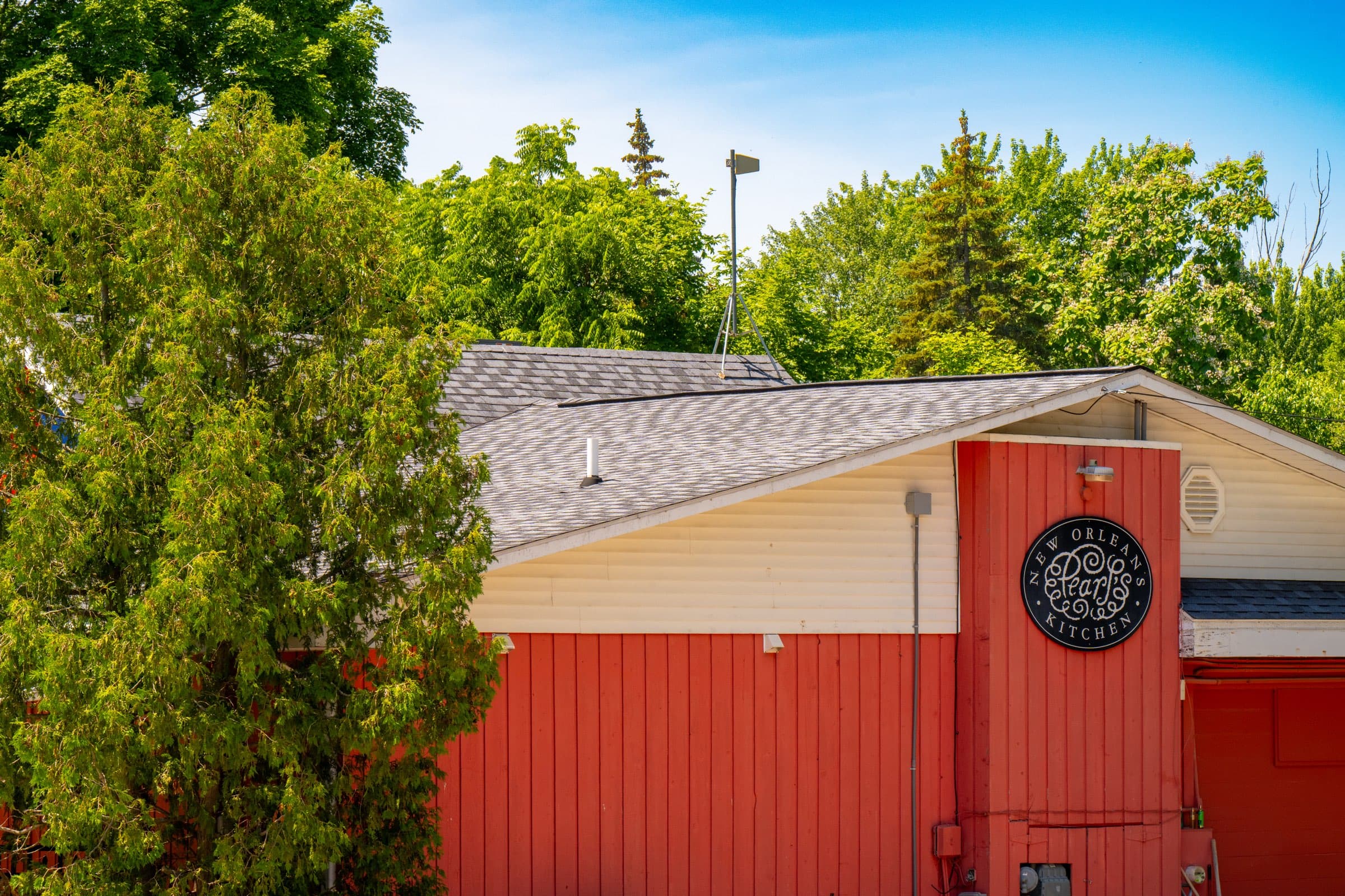 The red clapboard exterior of Pearl's New Orleans Kitchen in Elk Rapids