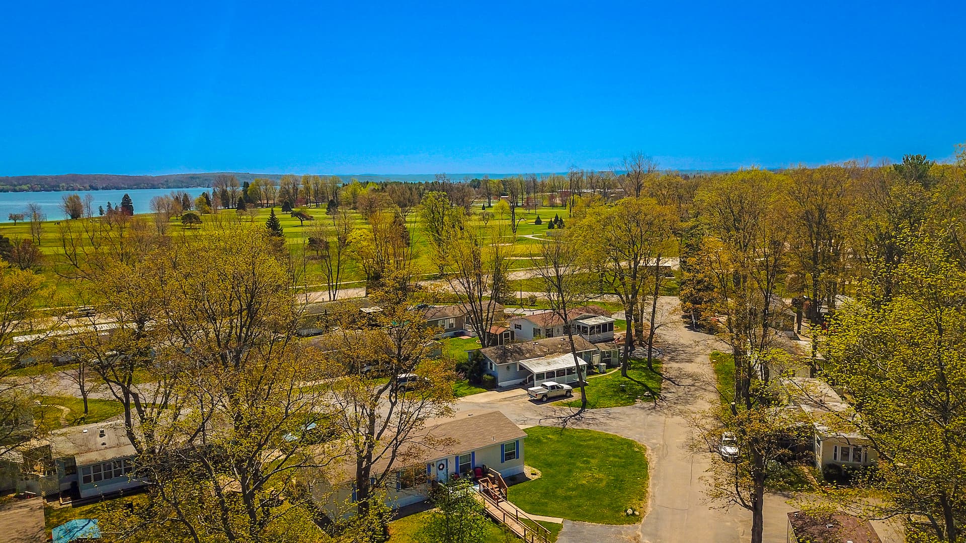 Aerial of Vacation Village's wooded acres above Bass Lake and the golf course