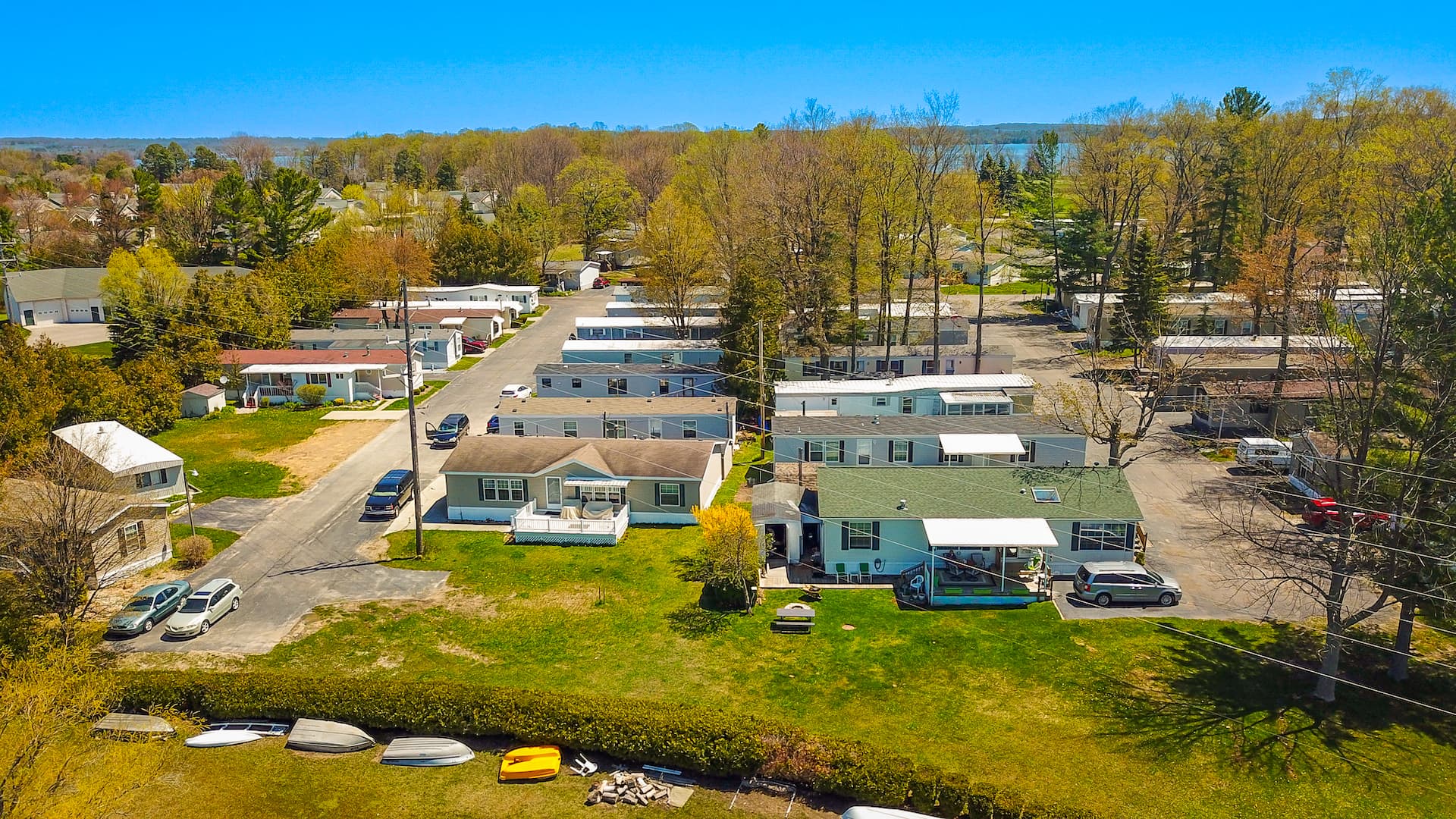 Aerial of lakeside home sites and canoe racks along the Bass Lake shore