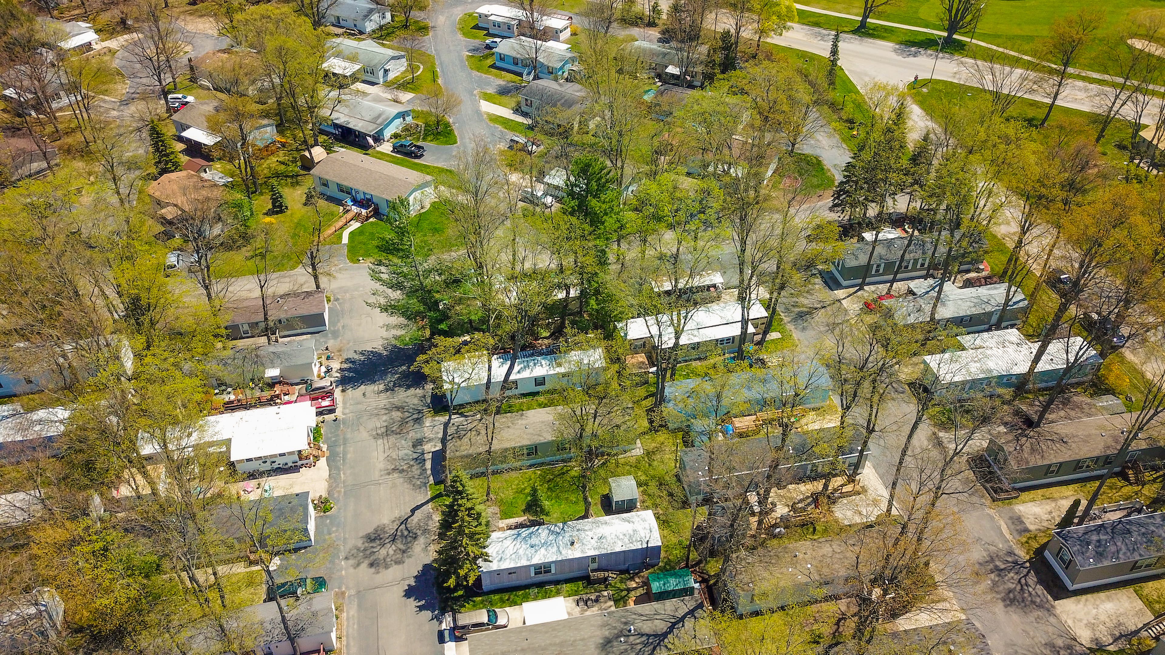Aerial of the tidy, tree-lined streets of the manufactured-home community